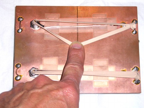 circuit board with rubber bands over signal paths